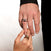 Close-up of two hands of a man  and a women wearing dragon-themed rings — a silver with rhodium plating dragon ring on the upper hand (Drakonis Drachen Ringe) and gold dragon rings on the lower hand on the women (Belarius Drachen Ringe) — symbolizing strength and connection.