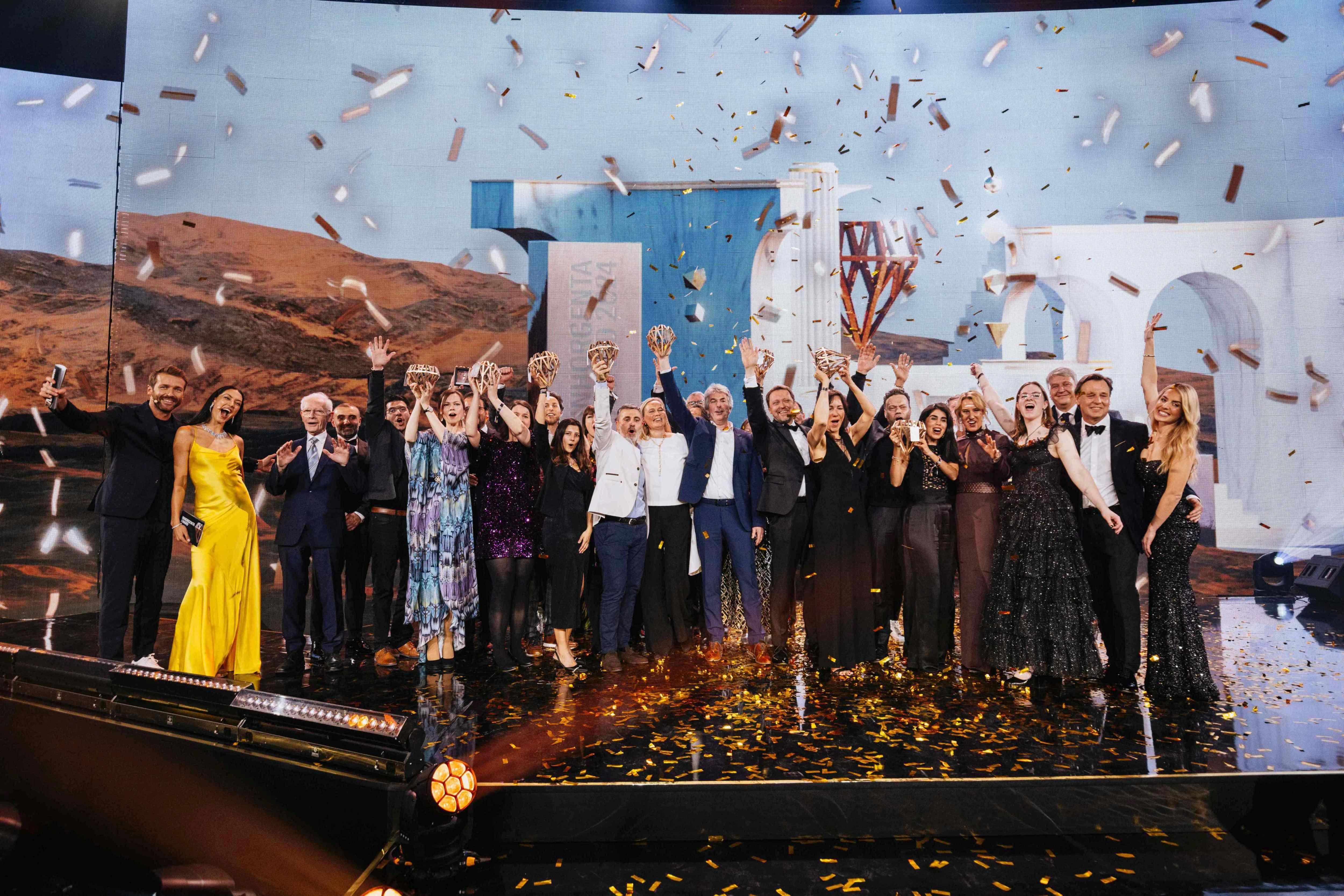 Seinerzeit team celebrating on stage after winning the Inhorgenta Fashion Jewelry of the Year 2024 award, holding trophies amid confetti.