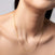Close-up of a woman wearing a fine gold box chain necklace, displayed elegantly on her neck, minimal and refined jewelry look.
