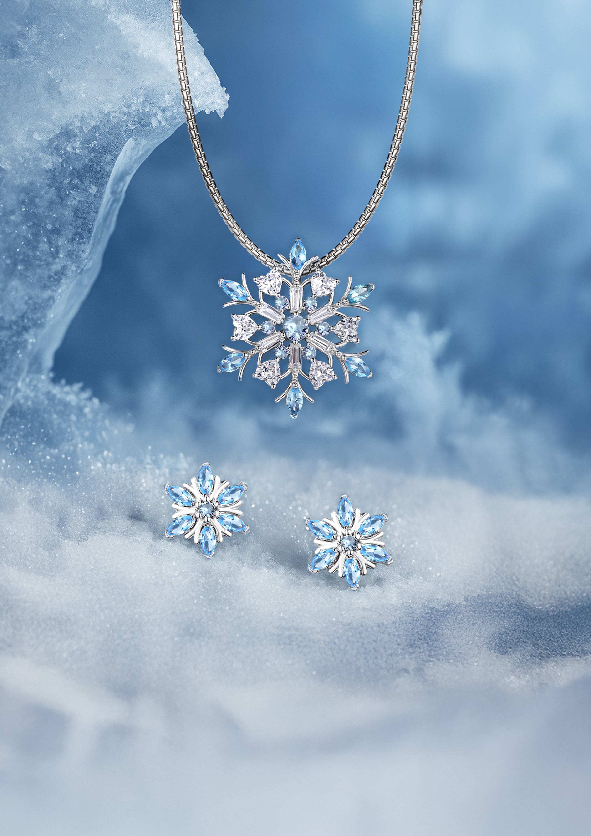 Seinerzeit Snowflake pendant and earrings set with marquise-cut icy blue CZ stones, showcased on a snowy winter scene — Christmas jewelry collection