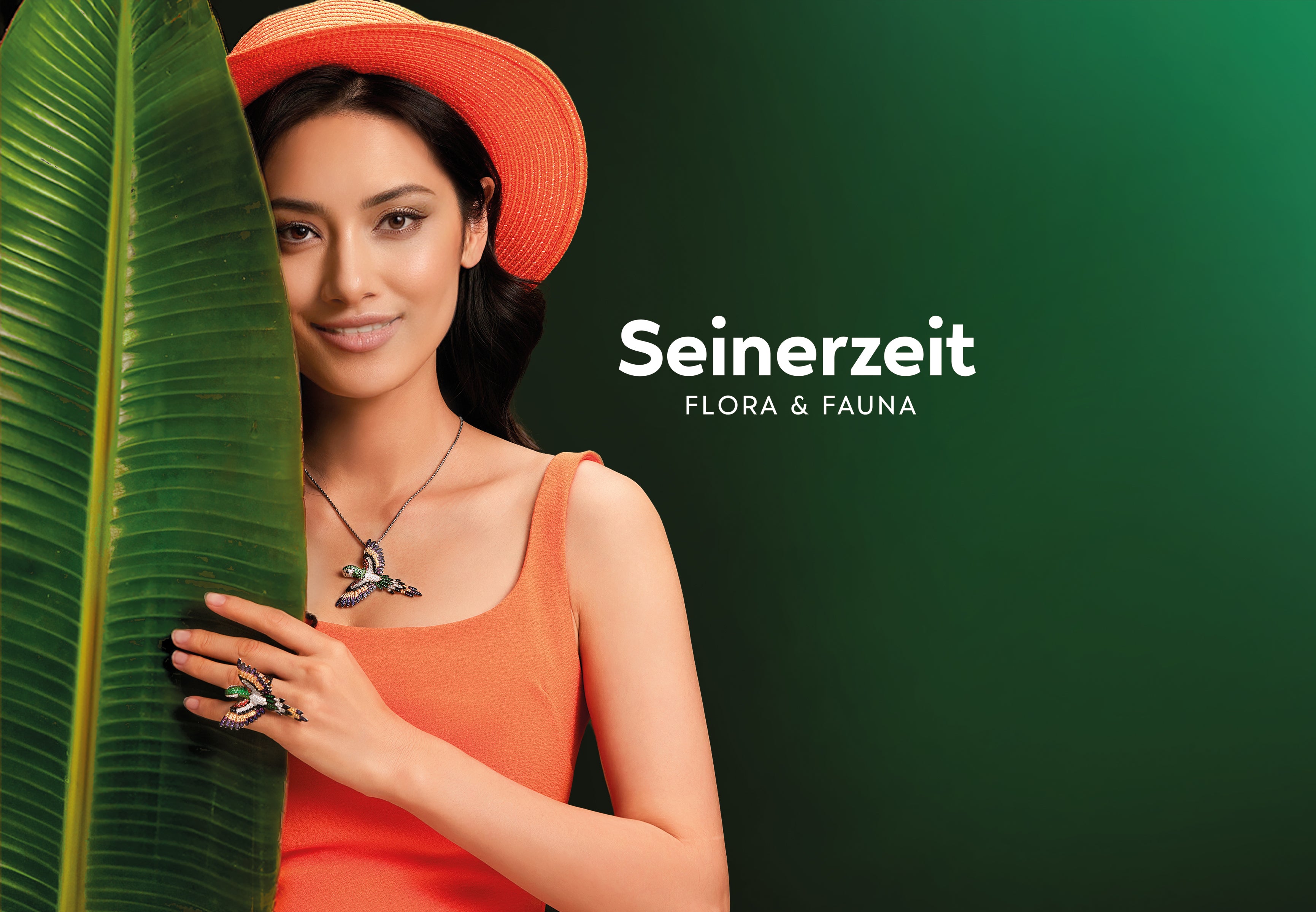 Seinerzeit Flora & Fauna newsletter banner with woman in orange dress and hat wearing parrot jewelry, standing beside a large tropical leaf.