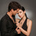 Elegant couple wearing matching dragon-themed jewelry from Seinerzeit Flora & Fauna — the woman styled in the Belarius snake pendant, Drakonis dragon stud earrings, and a statement ring, while the man wears the Drakonis dragon pendant — both dressed in black against a dark studio background