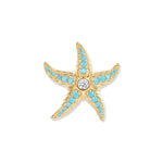 Golden starfish with turquoise zirconia in the arms and a sparkling stone in the center, inspired by sunny, clear aquatic worlds